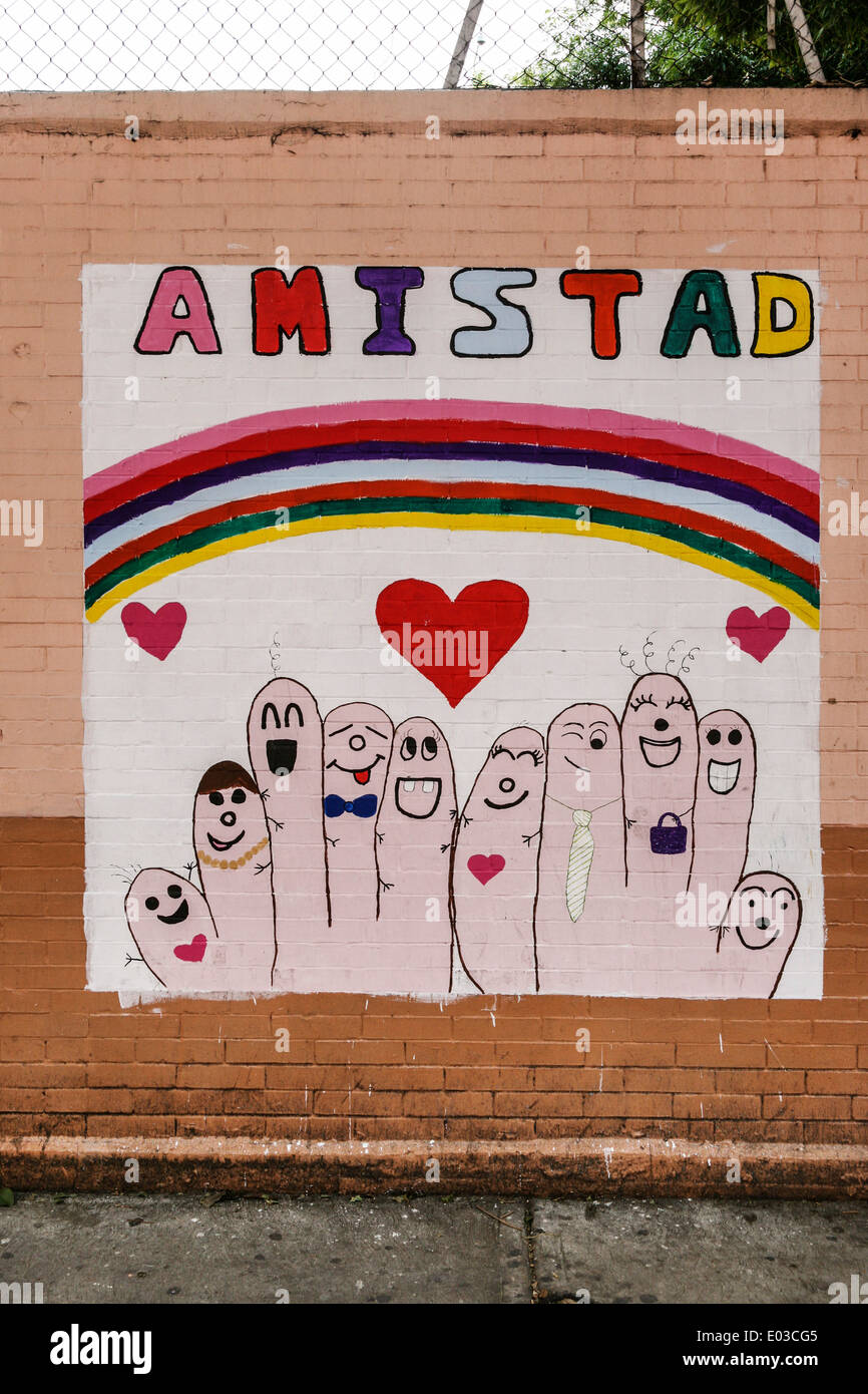 delightful wall painting painted by students on street side schoolyard wall depicting friendship as happy rainbow abstraction Stock Photo