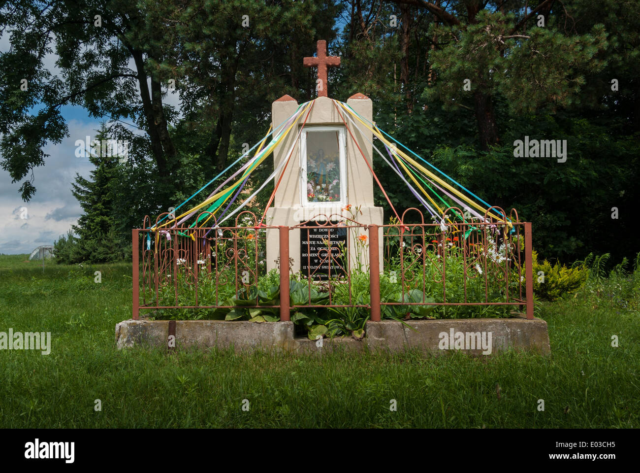 Traditional roadside Roman Catholic Shrine decorated with Ribbons and Flowers, near Sokołów Podlaski, Poland Stock Photo