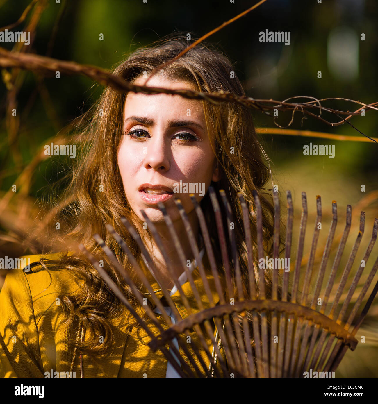 Woman With A Rake Beautiful fashionable woman and rake in the garden, springtime Stock ...