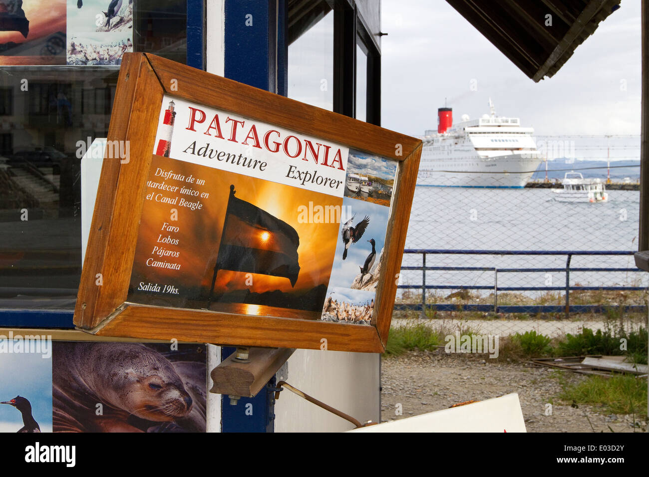 Patagonia adventure travel sign with cruise ship in background preparing to leave Ushuaia for tour of Antarctica. Stock Photo