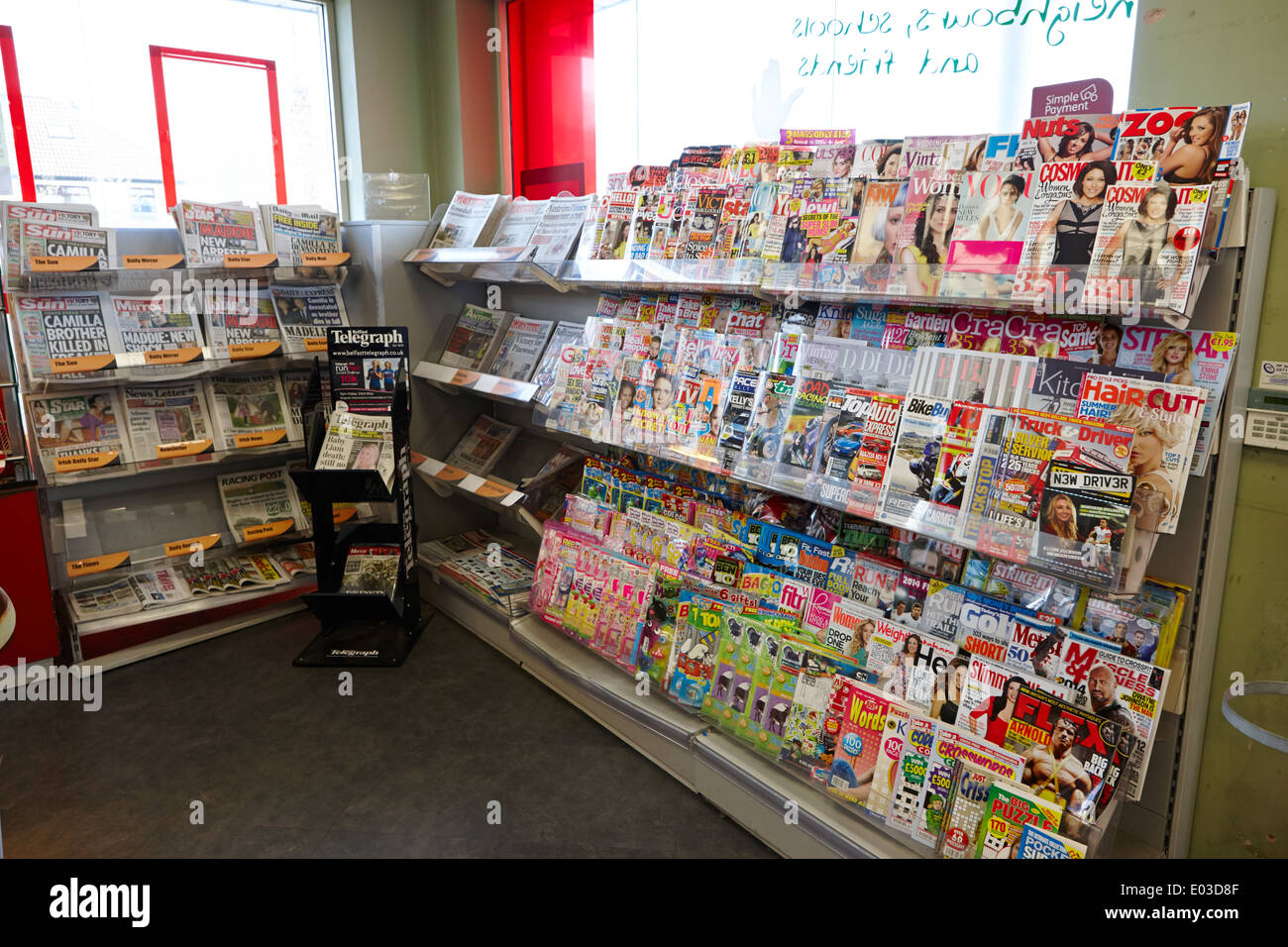 various magazines and newspapers on sale in a filling station convenience store in northern ireland Stock Photo