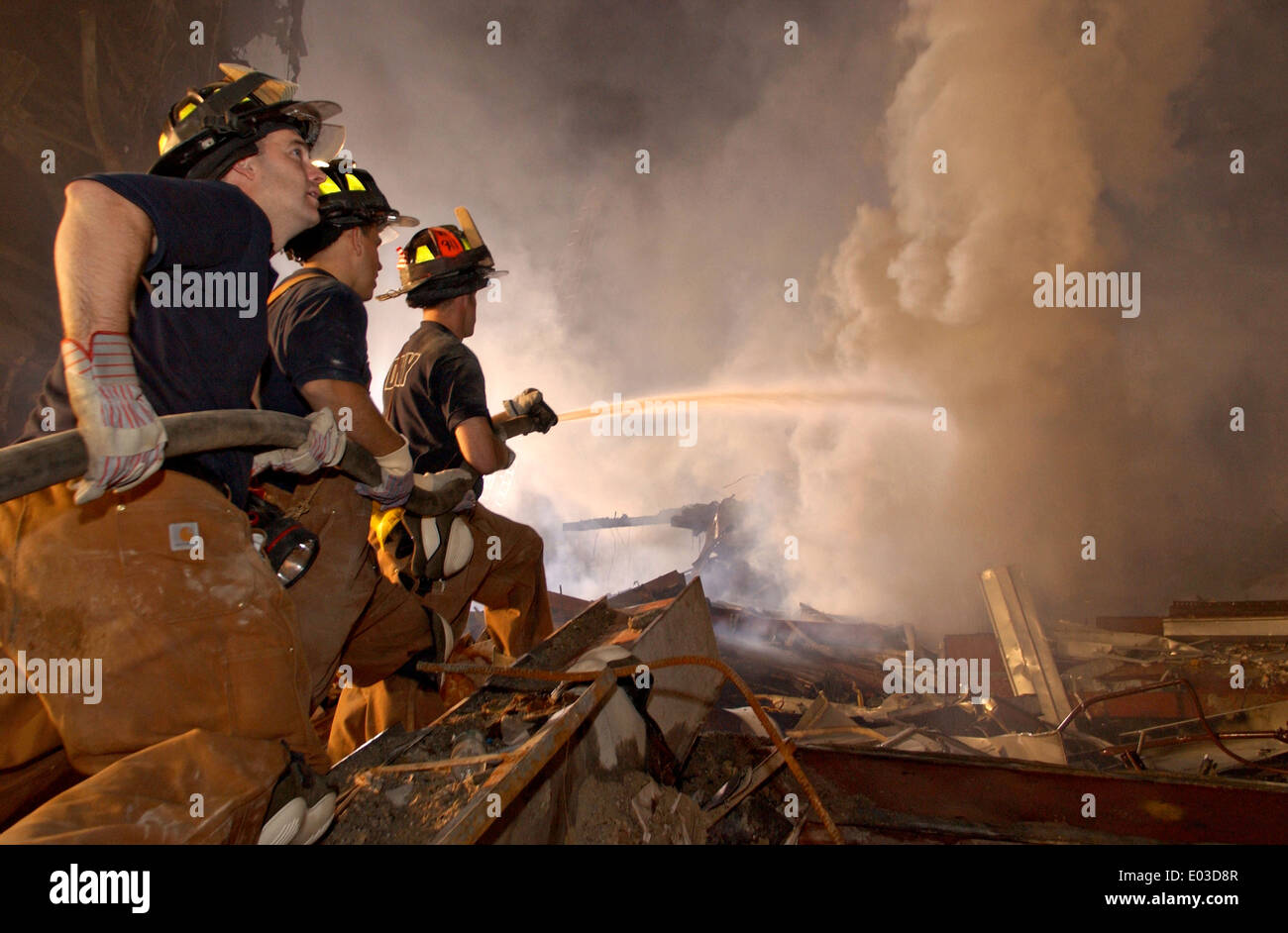 New York City Firemen battle fires amongst the wreckage of the World Trade Center in the aftermath of a massive terrorist attack which destroyed the twin towers killing 2,606 people September 19, 2001 in New York, NY. Stock Photo