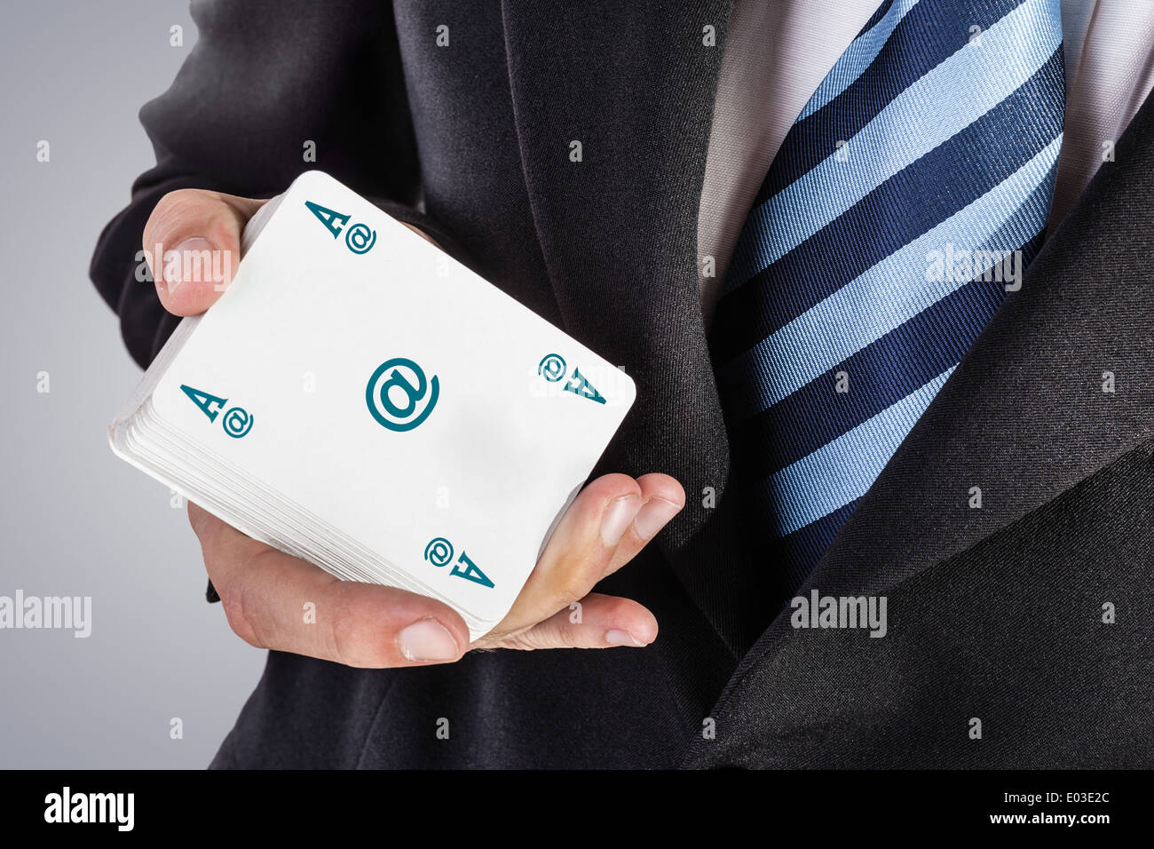an elegant young businessman showing an ace in his hand Stock Photo