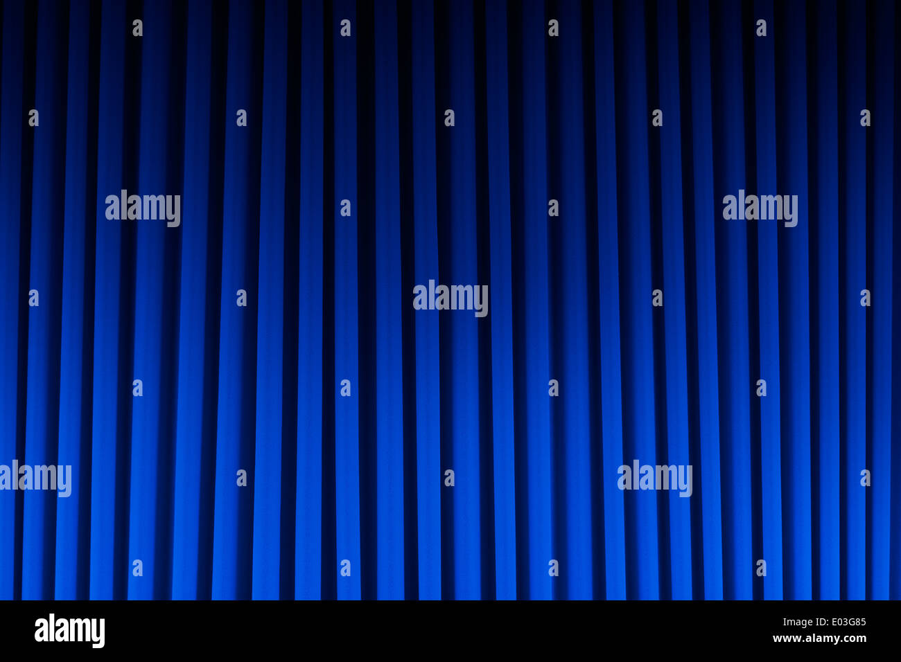 Blue Velvet Theater Curtain Dim Lite Background. Stock Photo
