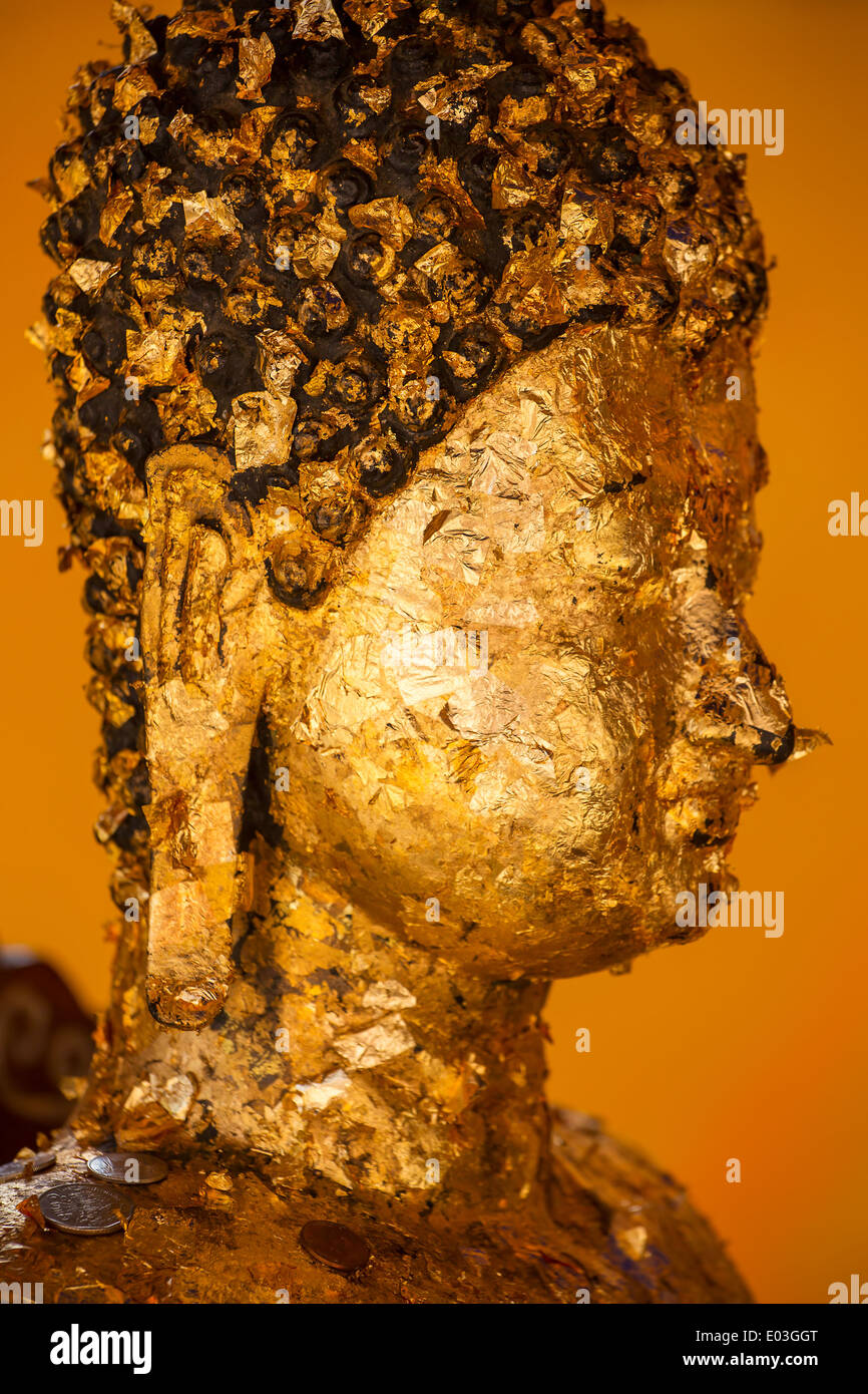 Buddha statue covered with golden papers Stock Photo Alamy