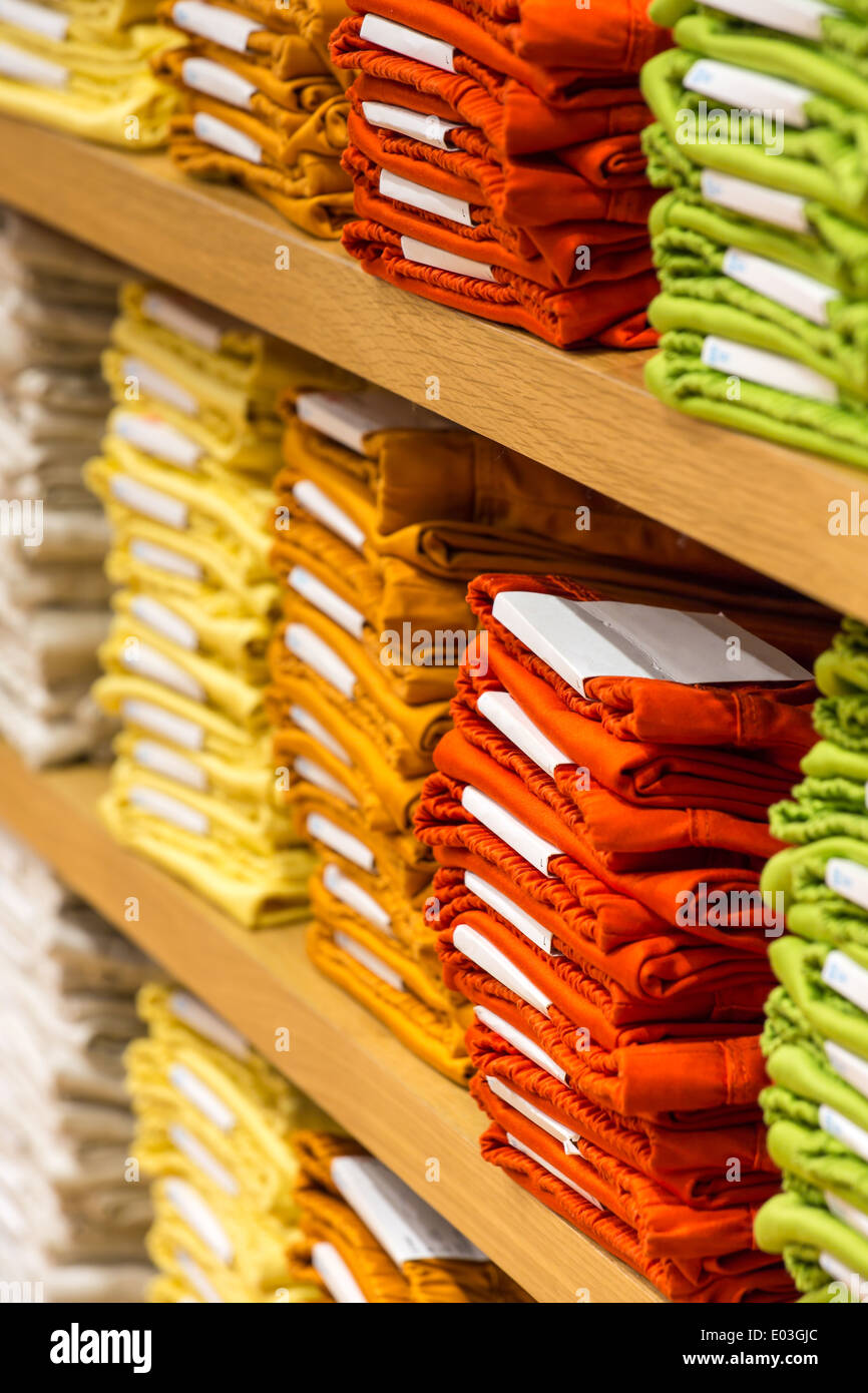 Neat stacks of folded clothing on the shop shelves Stock Photo Alamy