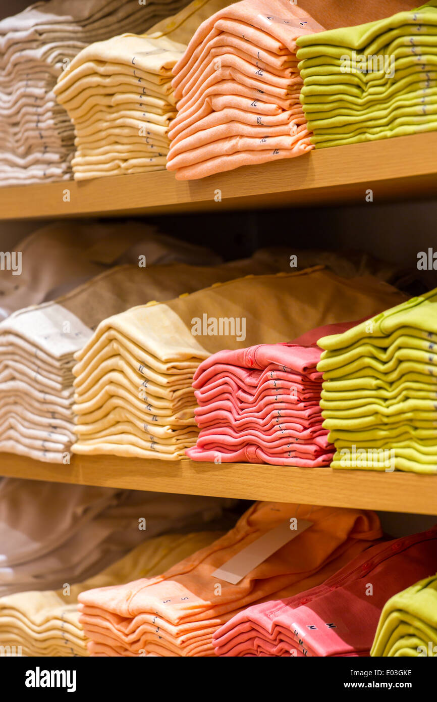 Neat stacks of folded clothing on the shop shelves Stock Photo Alamy