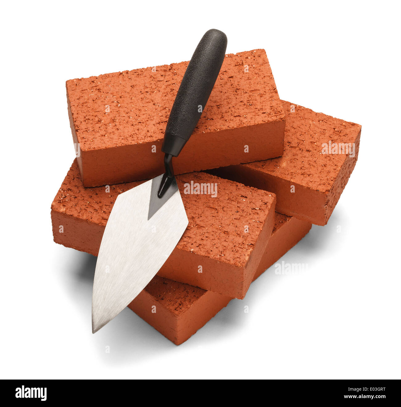 Pile of bricks with trowel isolated on a white background. Stock Photo