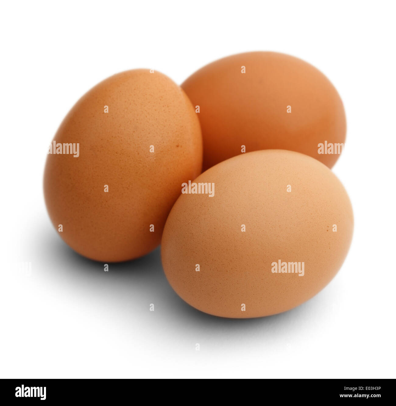 Three Brown Chicken Eggs Isolated on White Background. Stock Photo