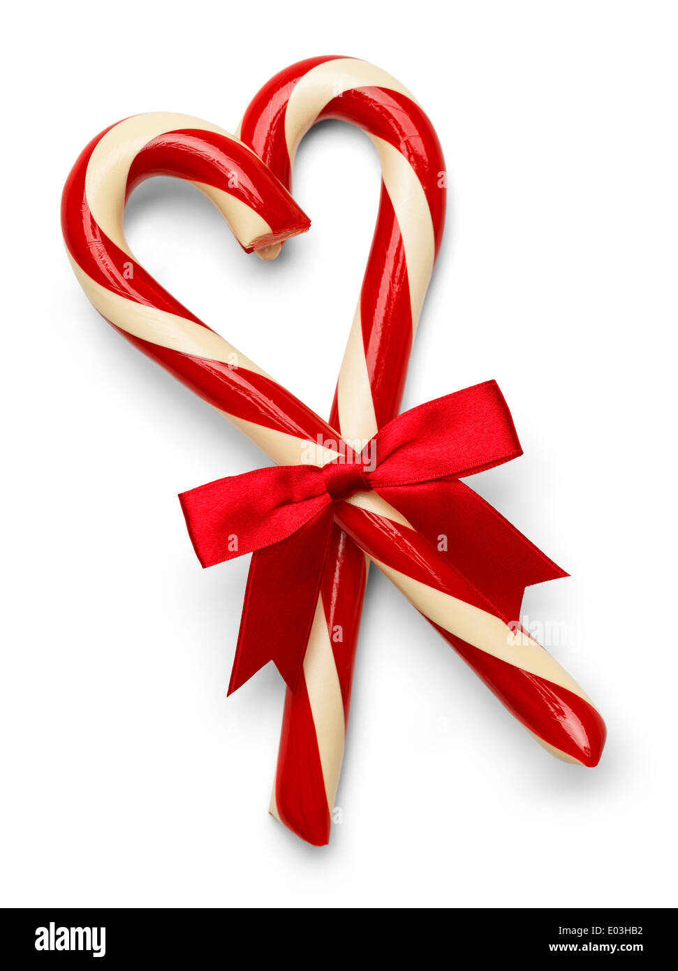 Two Candy Canes in Heart Shape with Red Bow Isolated on White Background. Stock Photo