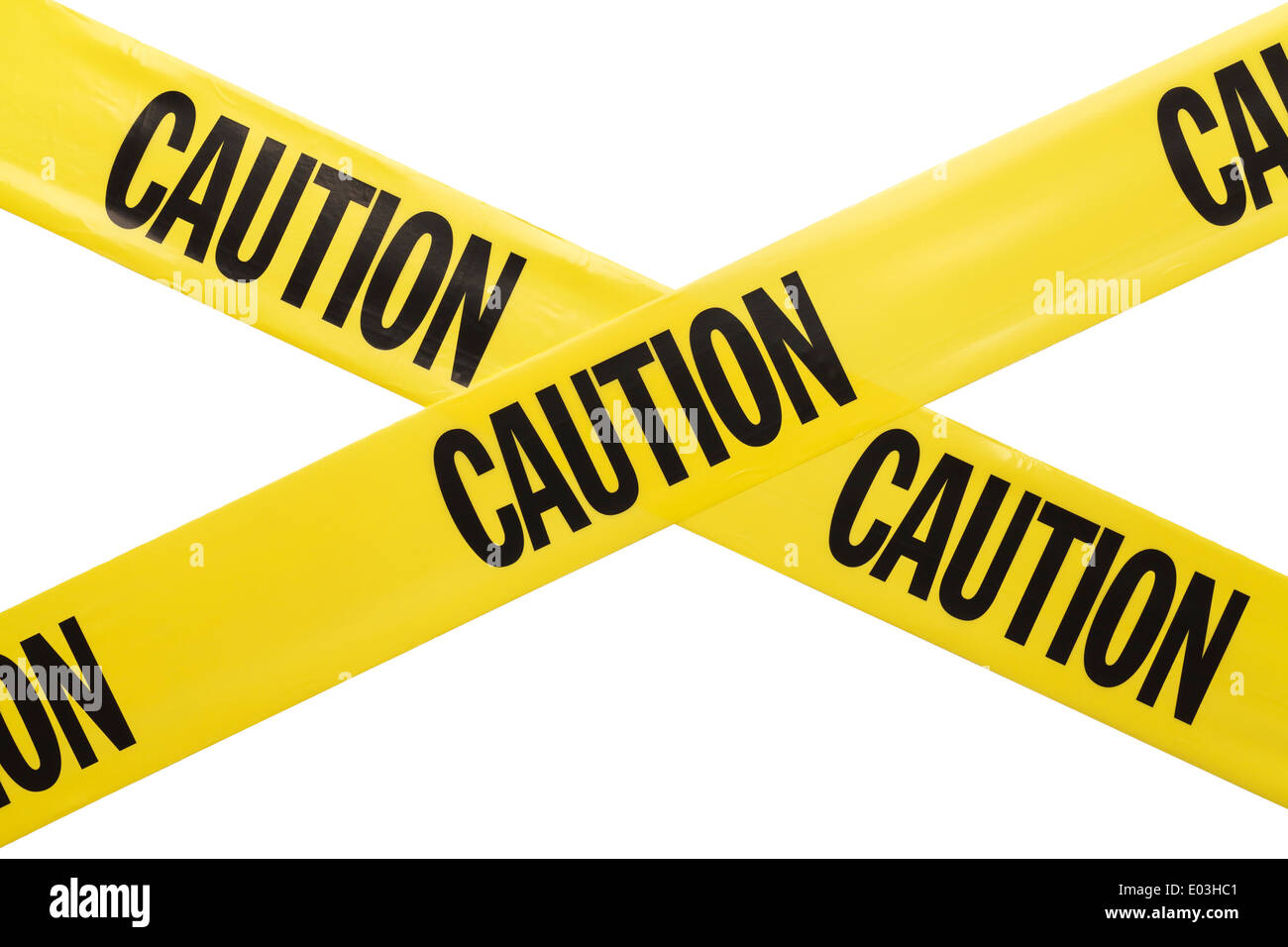 Yellow Plastic Caution Tape Criss Crossing Isolated on White Background. Stock Photo