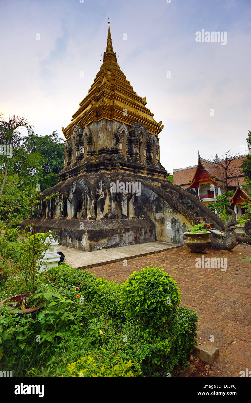 Gold spire of the chedi decorated with elephants in Wat Chiang Man Temple in Chiang Mai, Thailand Stock Photo