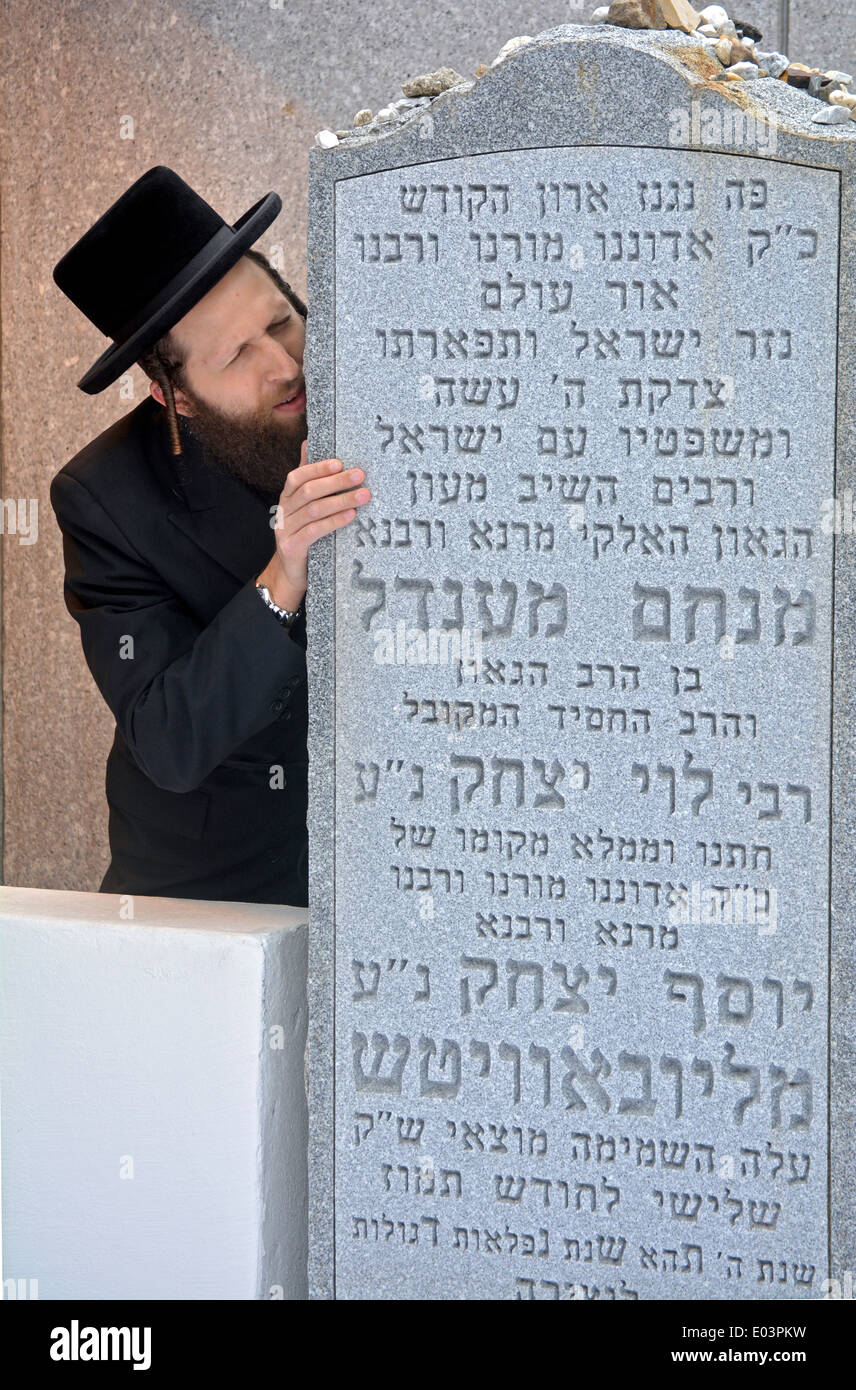 Religious Jewish man in fervent prayer at the Ohel, the burial place of