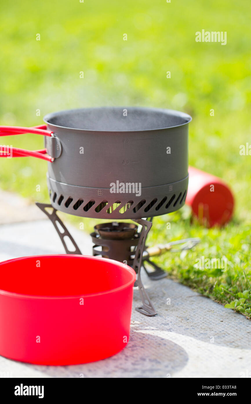 Water boiling on a small camping stove Stock Photo