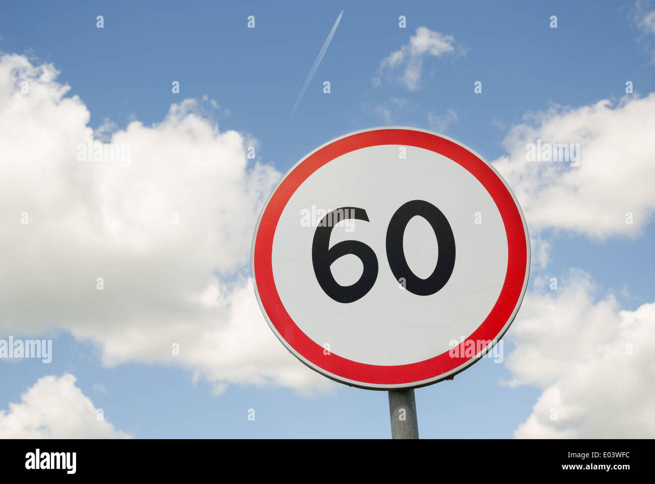 road traffic round sign limiting speed on blue sky background Stock Photo