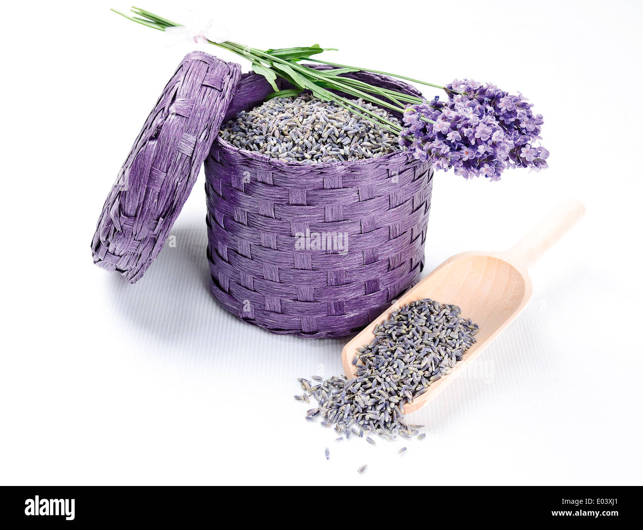 Fresh And Dry Lavender Flowers - Dried and fresh lavender flowers in a bast basket with wooden shovel. Stock Photo