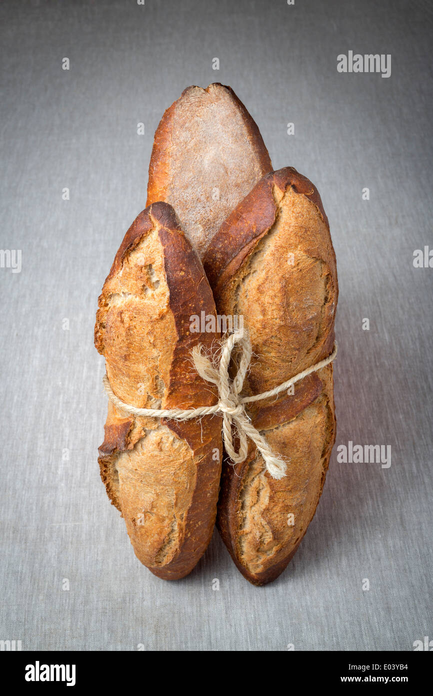 A display of breads tied up with a length of string (France). Présentation de pains liés avec une ficelle (France). Stock Photo