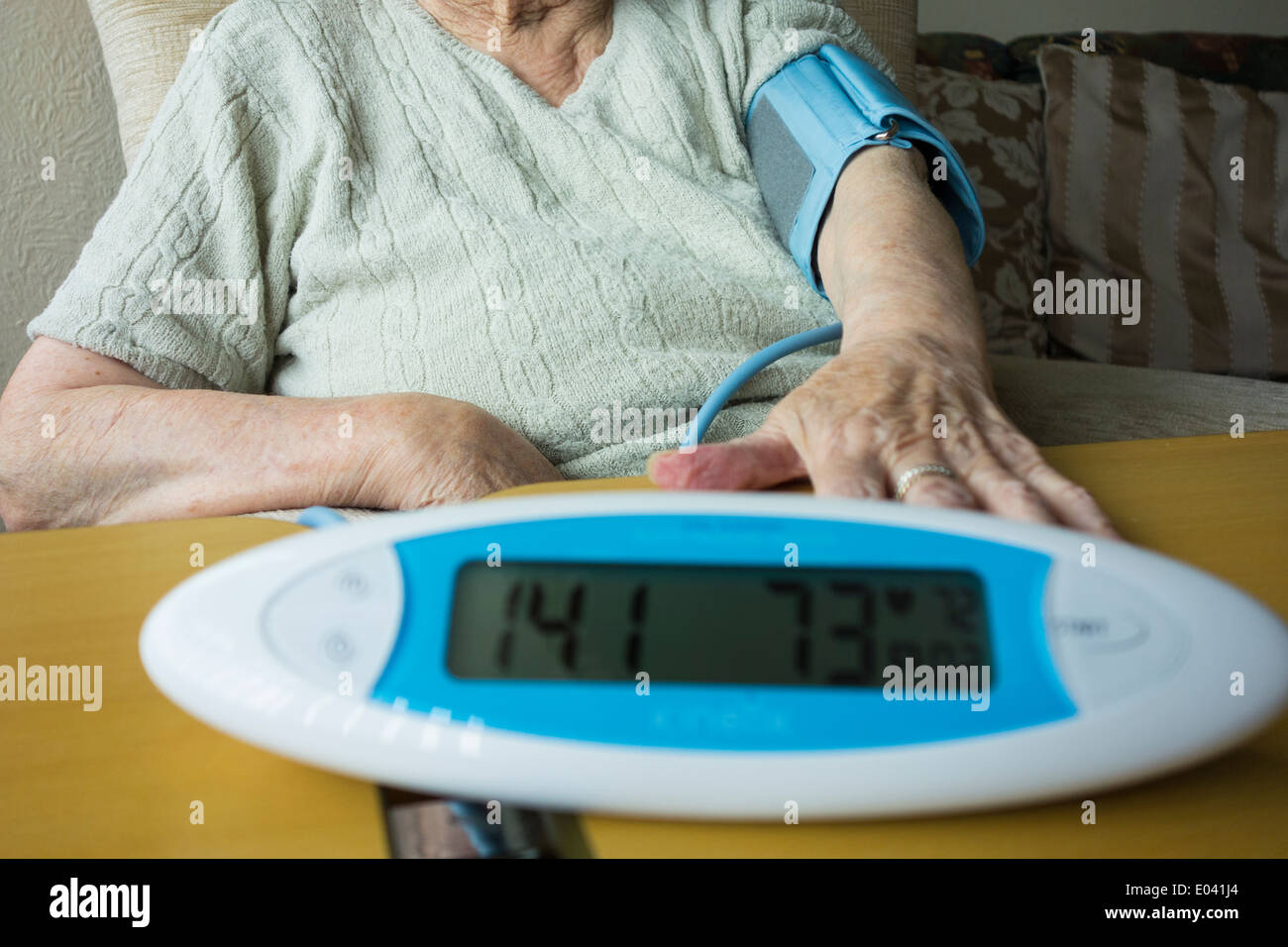 Elderly lady in her nineties having Blood Pressure ckecked at home Stock Photo