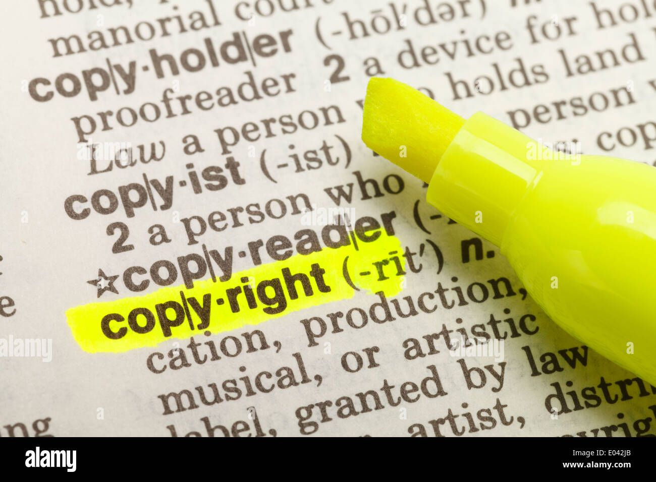 Yellow Highlighter And Marked Copyright Dictionary. Stock Photo