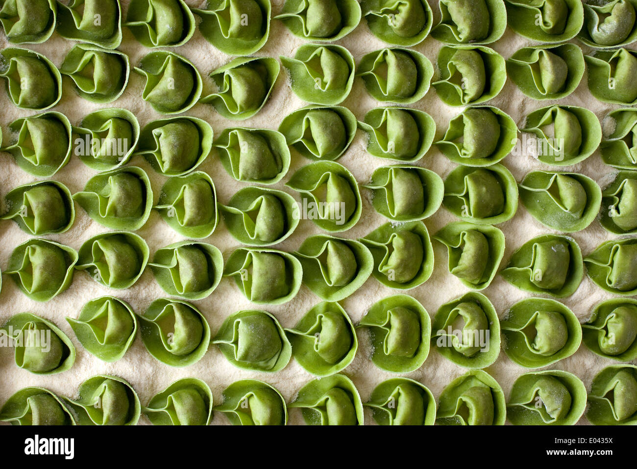 A tray full of green tortellini pasta waiting to be cooked Stock Photo