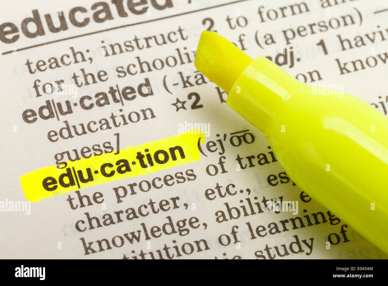 The Word Education Highlighted in Dictionary with Yellow Marker Highlighter Pen. Stock Photo