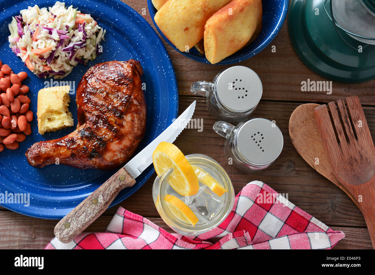 High angle shot of a barbecue chicken plate with cole slaw, pinto beans and corn bread Stock Photo