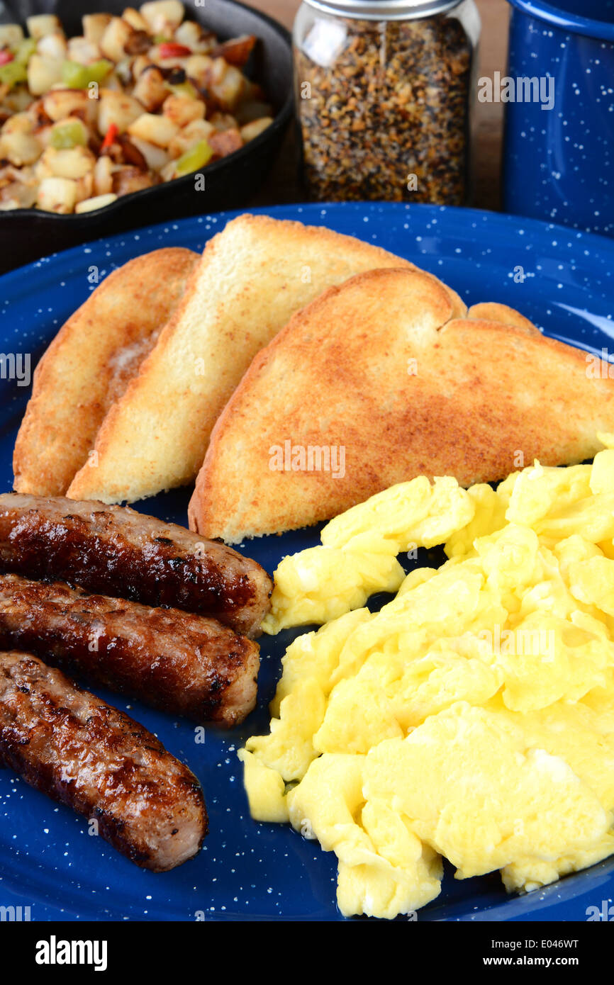 Closeup of a scrambled egg breakfast with sausage links, toast and hash brown potatoes. Stock Photo
