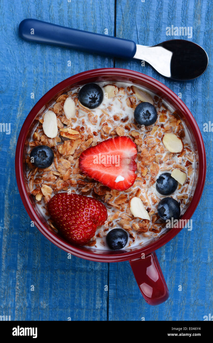 High angle photo of a large mug filled with a healthy whole grain cereal and fruit. Strawberries, blueberries and sliced almonds Stock Photo