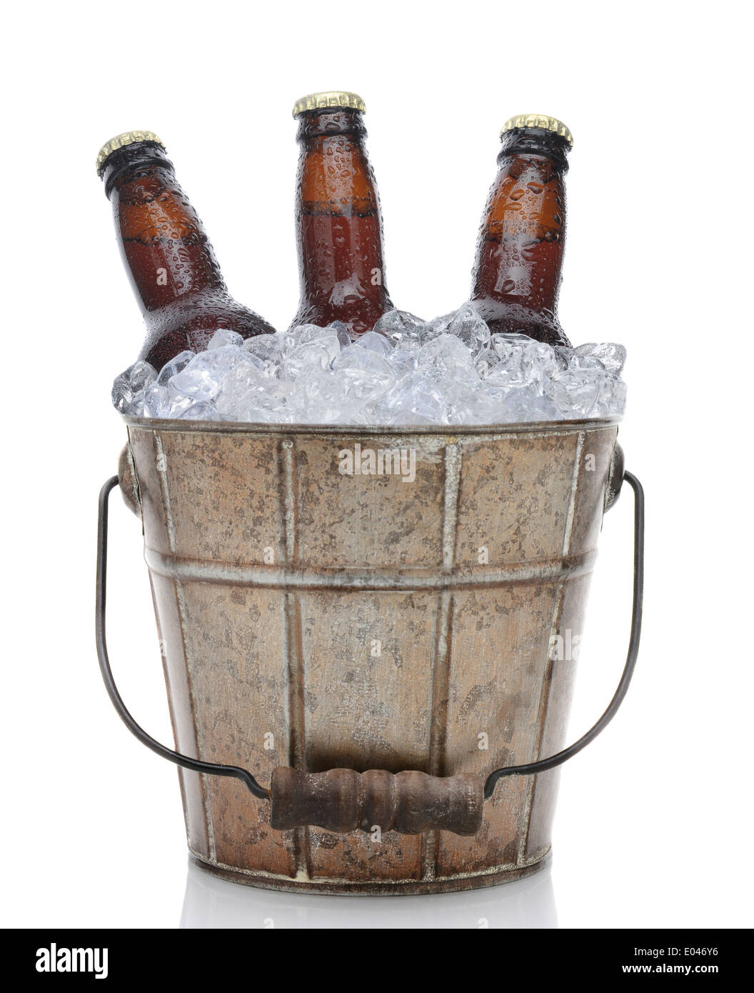 Closeup of an old fashioned beer bucket with three brown bottles of