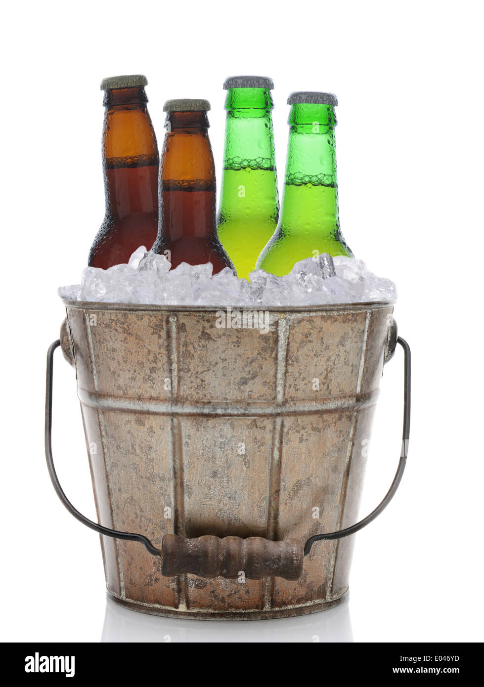 An old fashioned bucket filled with ice and beer bottles. Four brown