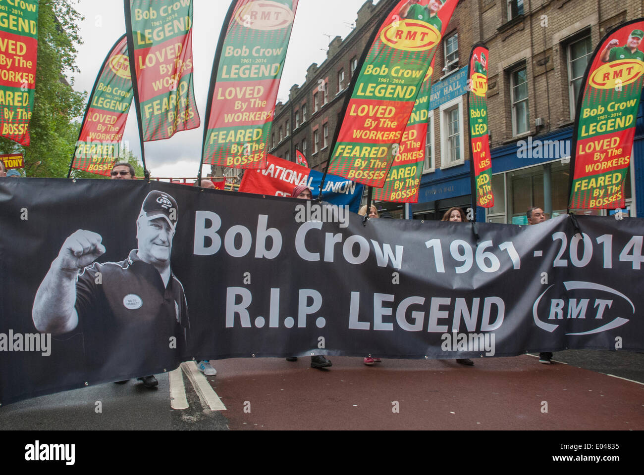 London, UK. 01st May, 2014. Supporters wave flags and hold a large banner during the May Day march honoring Bob Crow who led the RMT union before he passed away in March 2014. London, UK. Credit:  Peter Manning/Alamy Live News Stock Photo