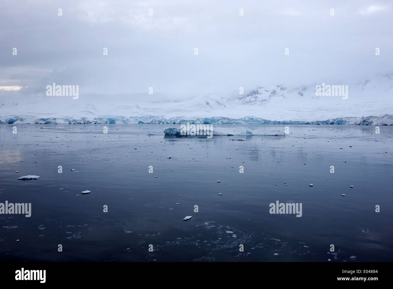 floating ice and snow covered landscape in Fournier Bay on Anvers Island Antarctica Stock Photo