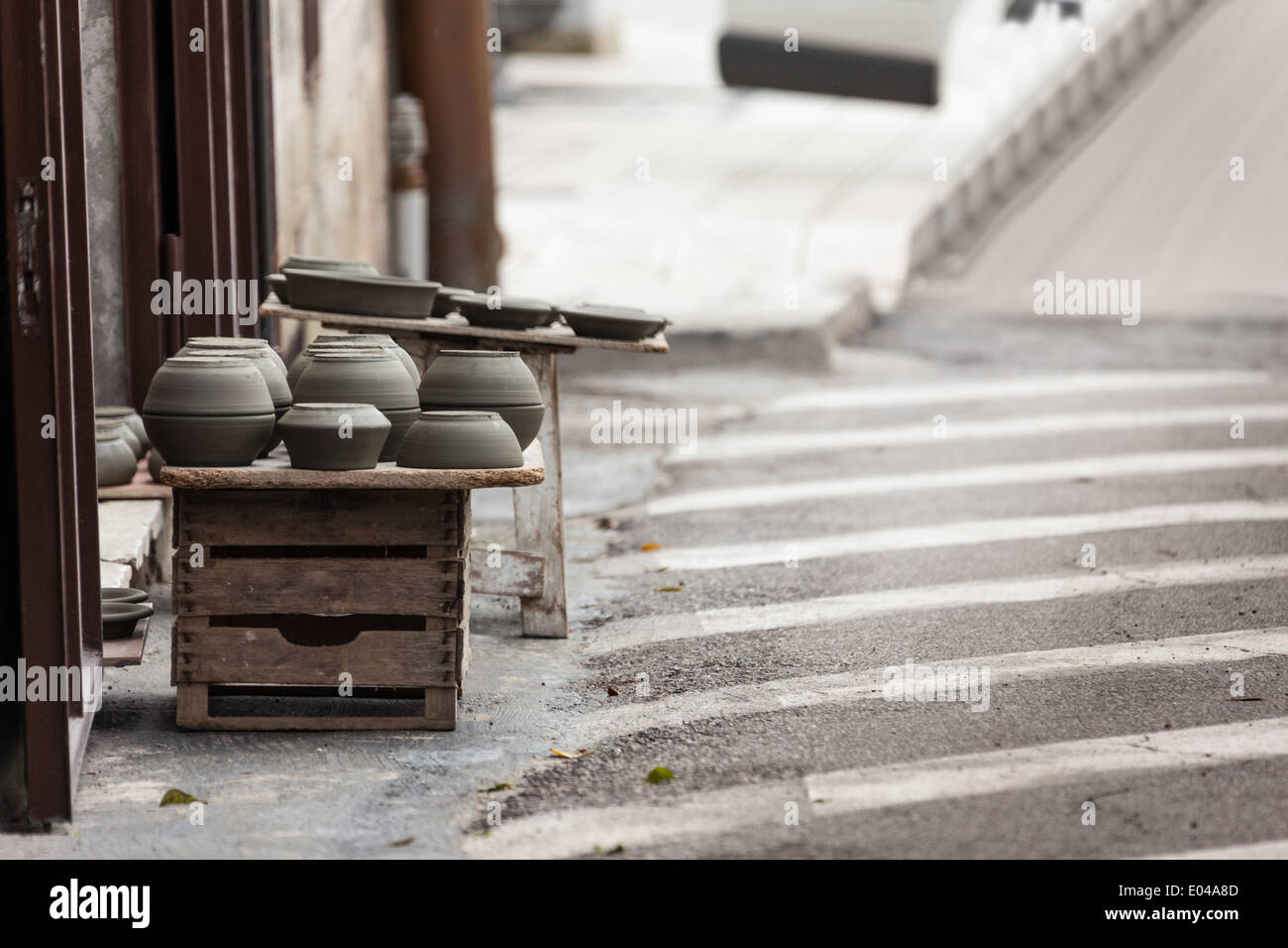 some crockery arranged on the street in a typical italian artisan shop