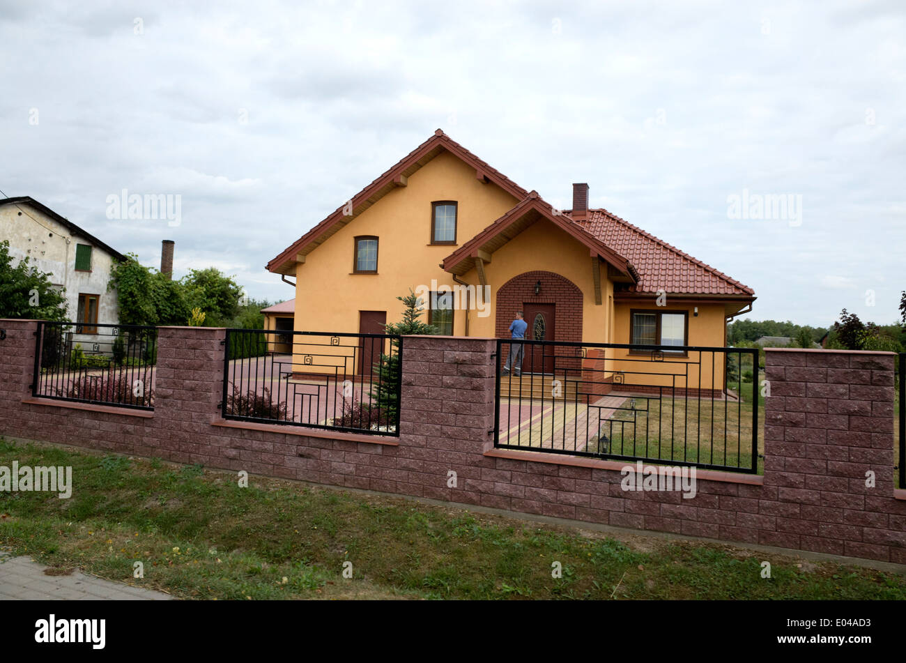 Modern Polish home with brick patio and wrought iron fence. Rawa Mazowiecka Central Poland Stock Photo