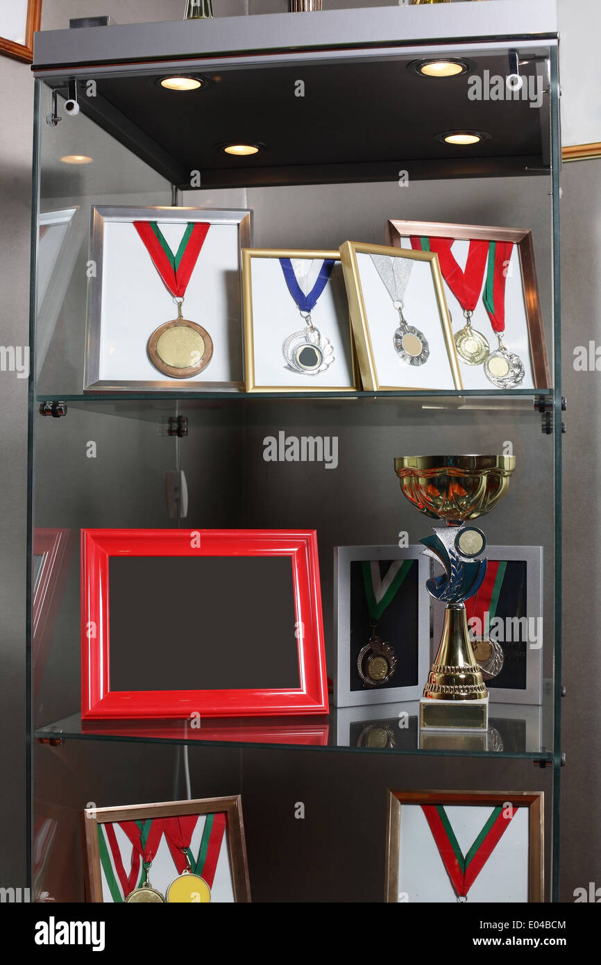clean cabinet with different gold and silver medals Stock Photo