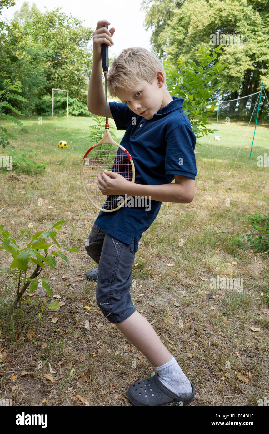 Polish boy age 10 playing air guitar with a badminton racquet. Zawady