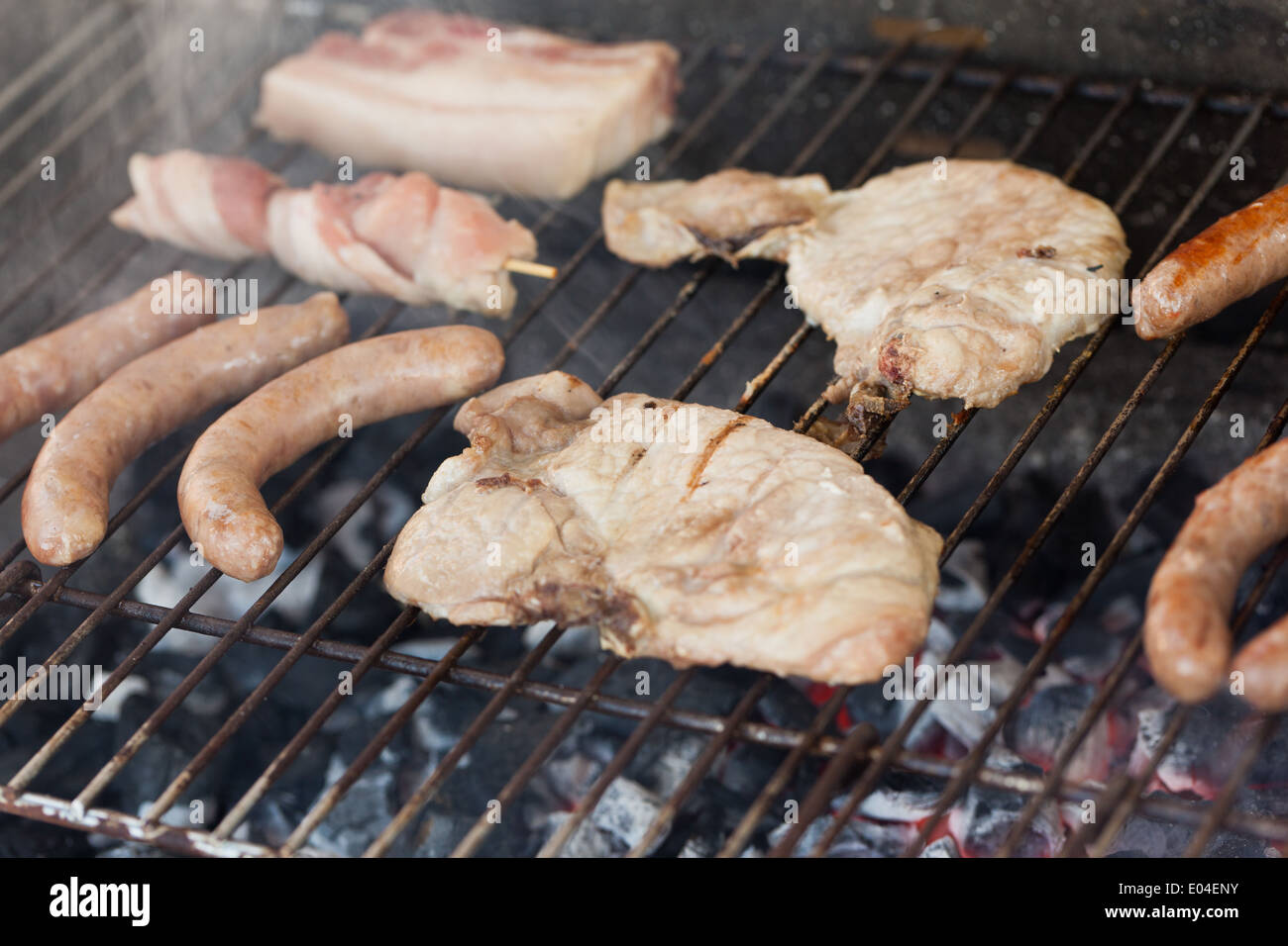 Several type of meats being cooked on a barbecue Stock Photo Alamy