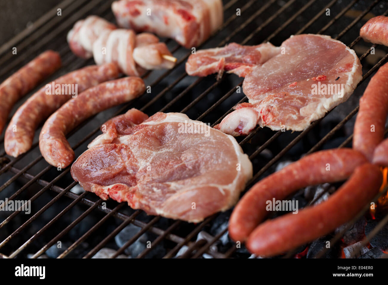 Several type of meats being cooked on a barbecue Stock Photo Alamy