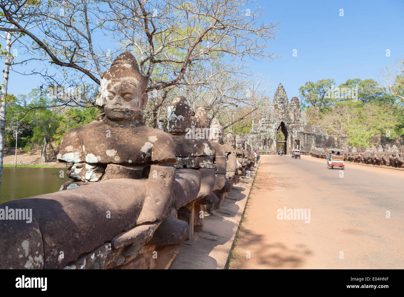 Deva statues aligned at the south gate causeway of Angkor Thom ...
