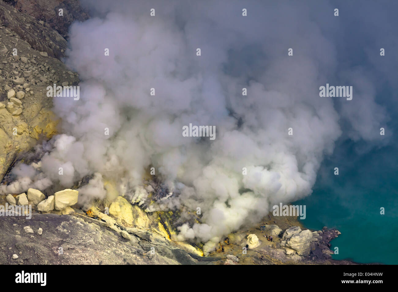 Sulfur mine near turquoise acid crater lake, Kawah Ijen, Banyuwangi Regency, East Java, Indonesia Stock Photo