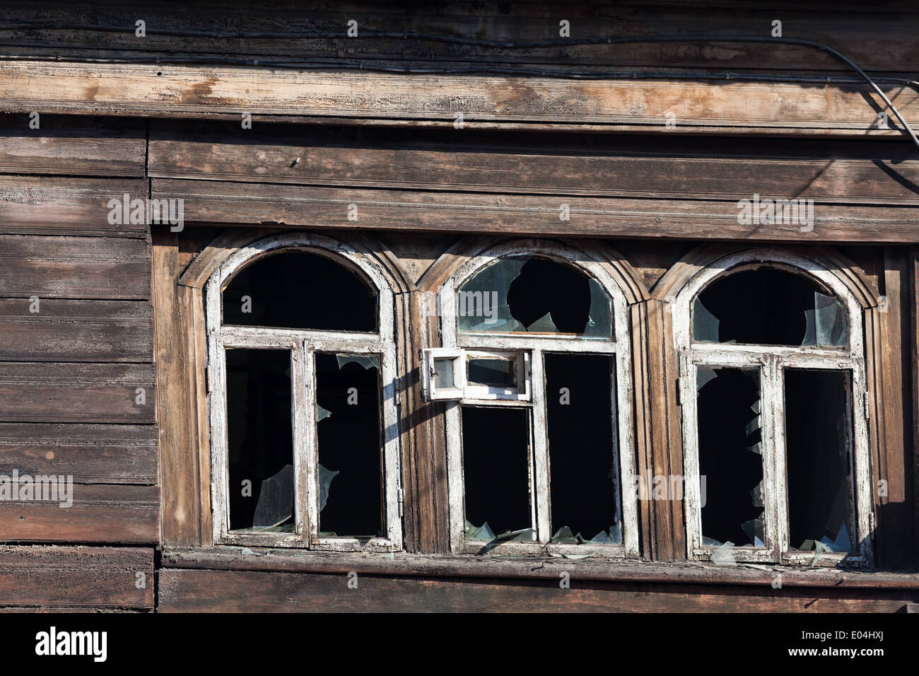 Windows with broken panes in wooden building, Irkutsk, Siberia, Russia Stock Photo
