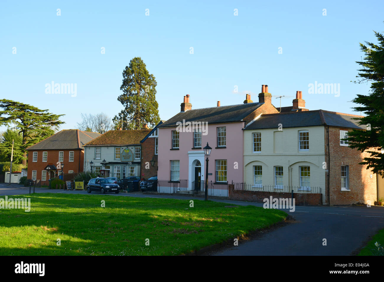 Period houses and Barley Mow Pub on The Green, Englefield Green, Surrey, England, United Kingdom Stock Photo