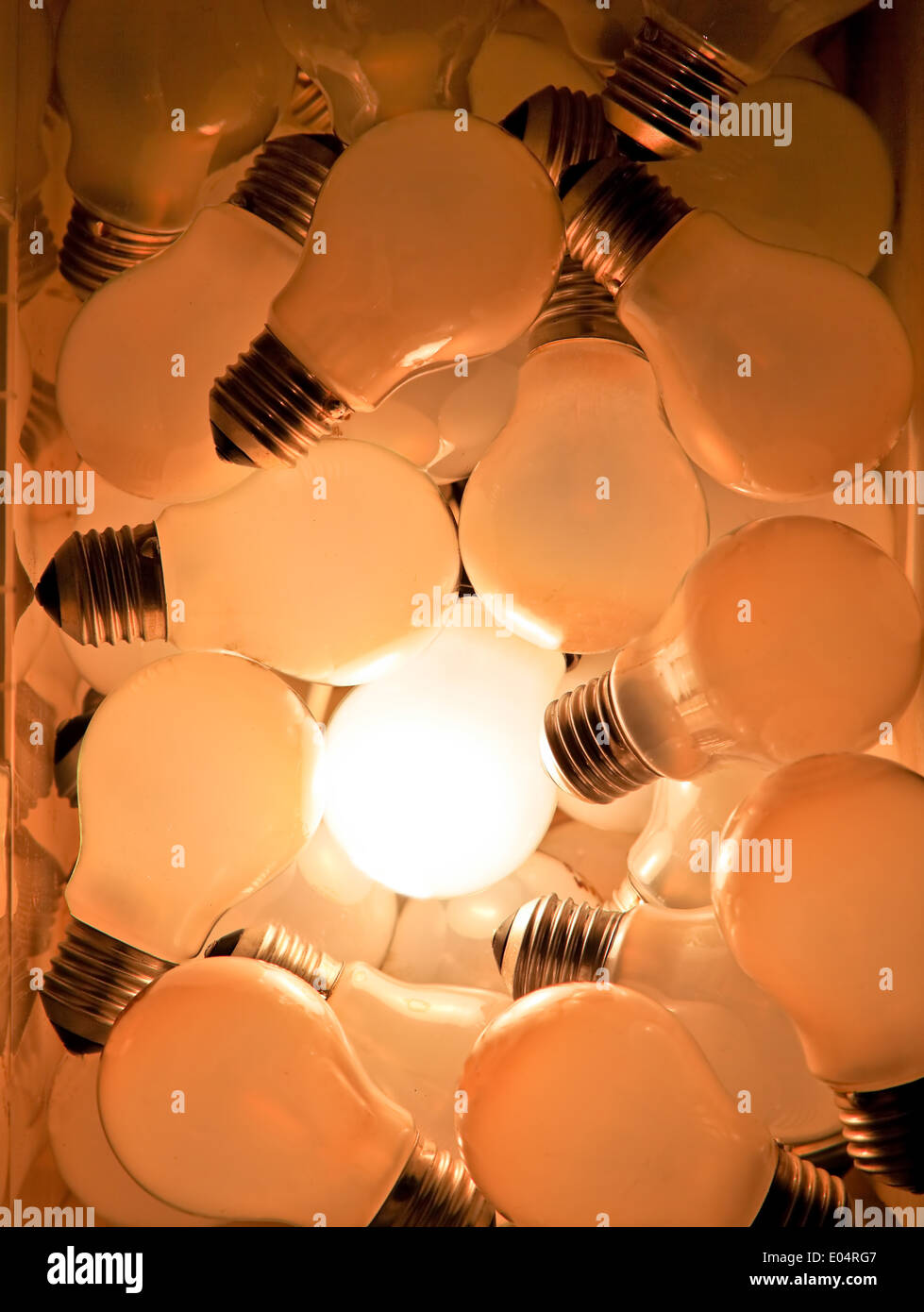 Many light bulbs, one shines, symbol for ideas, Viele Gluehbirnen, eine leuchtet,Symbol fuer Ideen Stock Photo