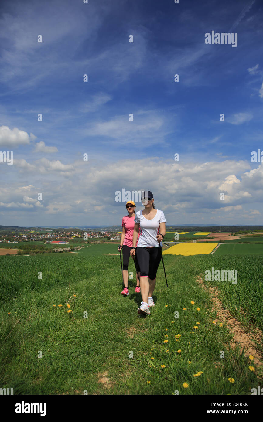 women nordic walking through rural landscape Stock Photo