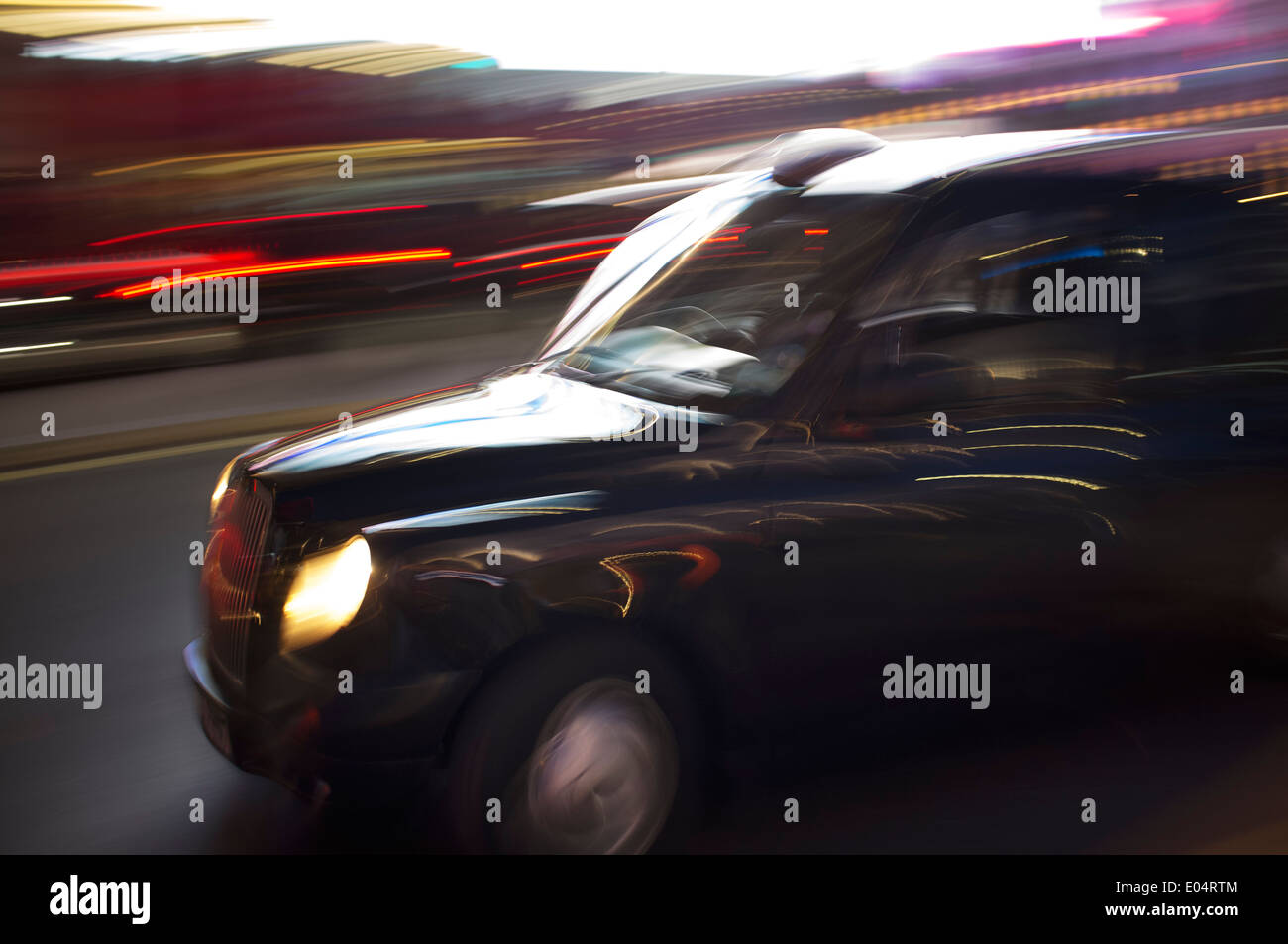 Abstract blurry image of a London taxi cab driving on a street. Stock Photo