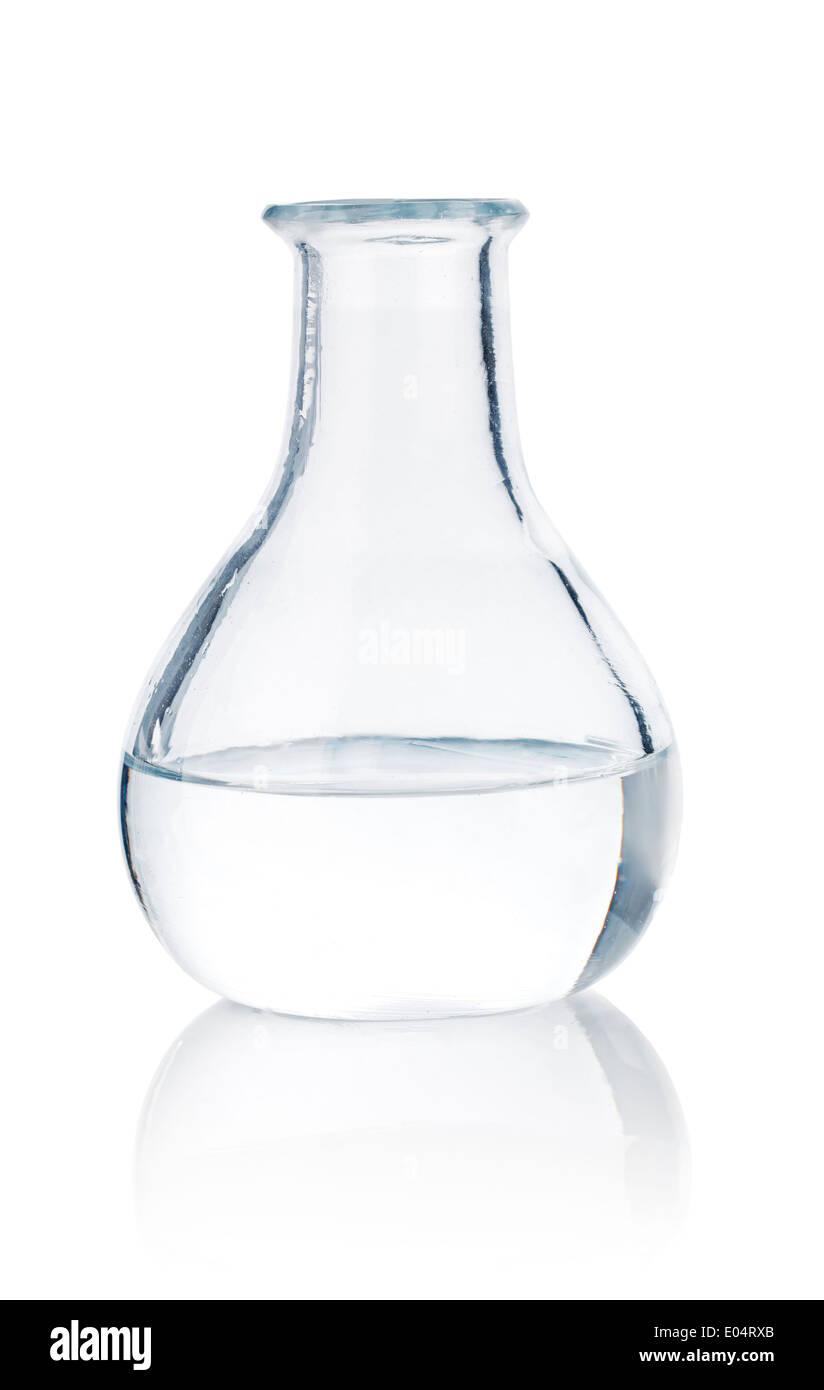 Old half-full glass bottle on reflective surface. Stock Photo