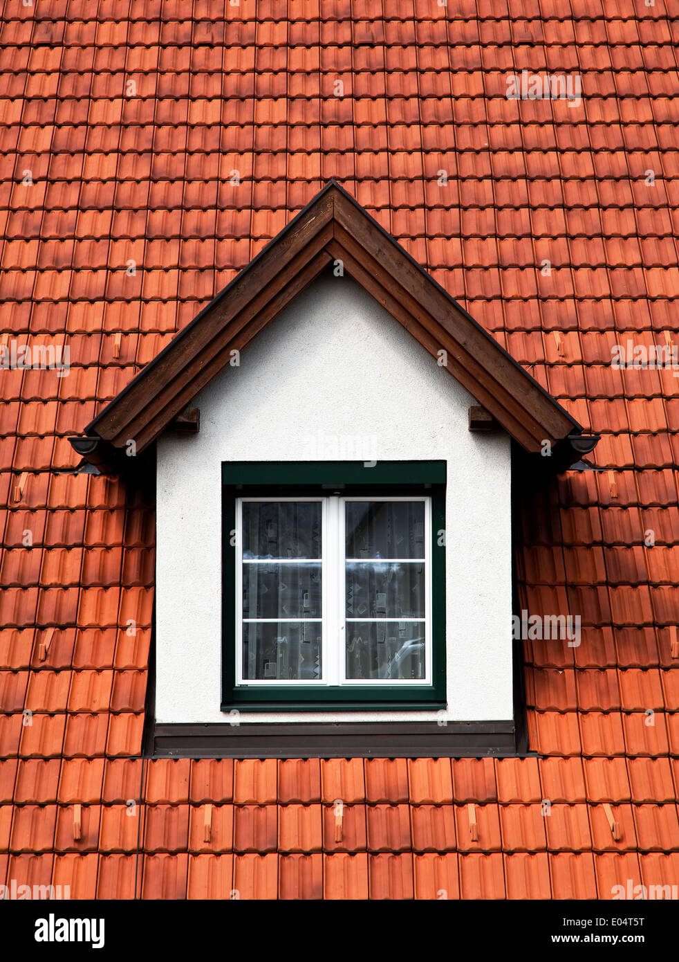 Dormer with rung window in a brick covered roof, Dachgaube mit Sprossenfenster in einem Ziegel gedeckten Dach Stock Photo