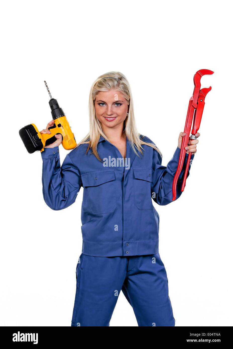 Young woman in blue Arbeits clothes with drill, Junge Frau in blauer Arbeits Kleidung mit Bohrmaschine Stock Photo