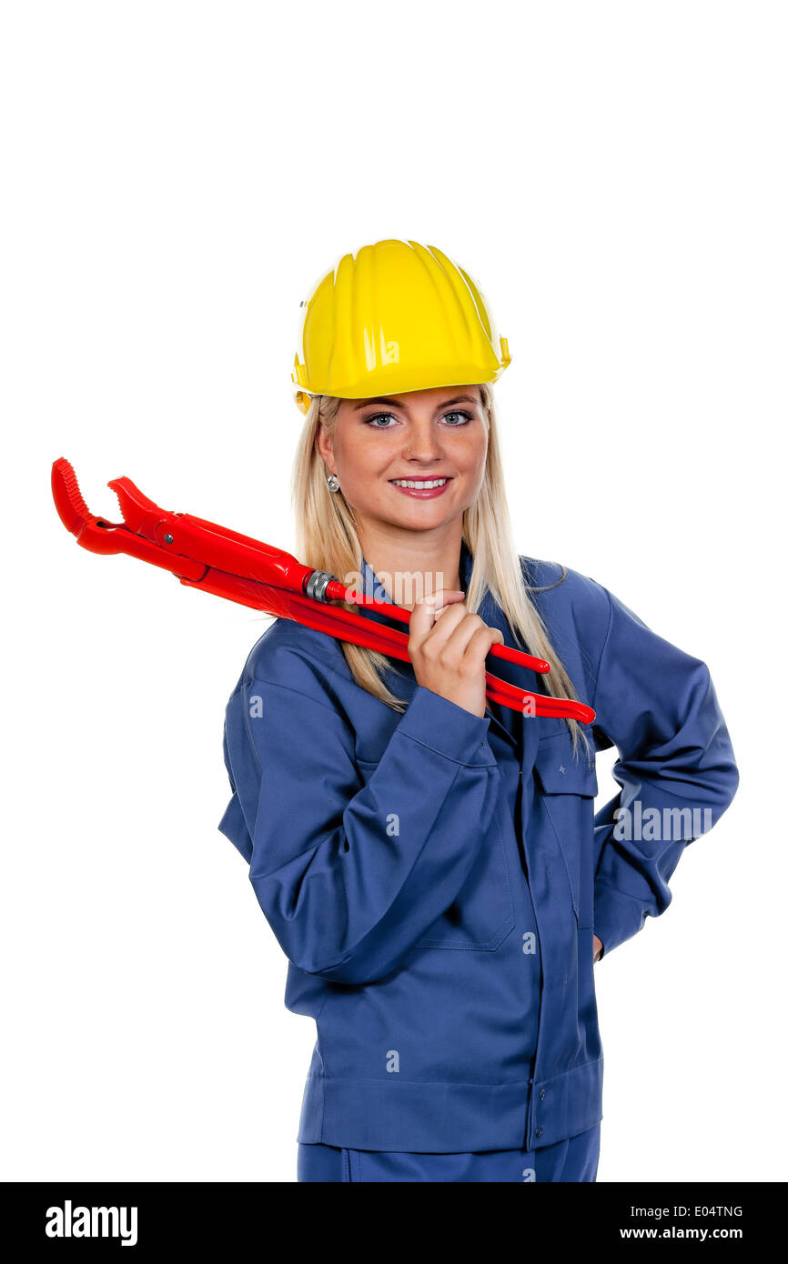 Young woman in blue Arbeits clothes with gaspipe pliers., Junge Frau in blauer Arbeits Kleidung mit Rohrzange. Stock Photo
