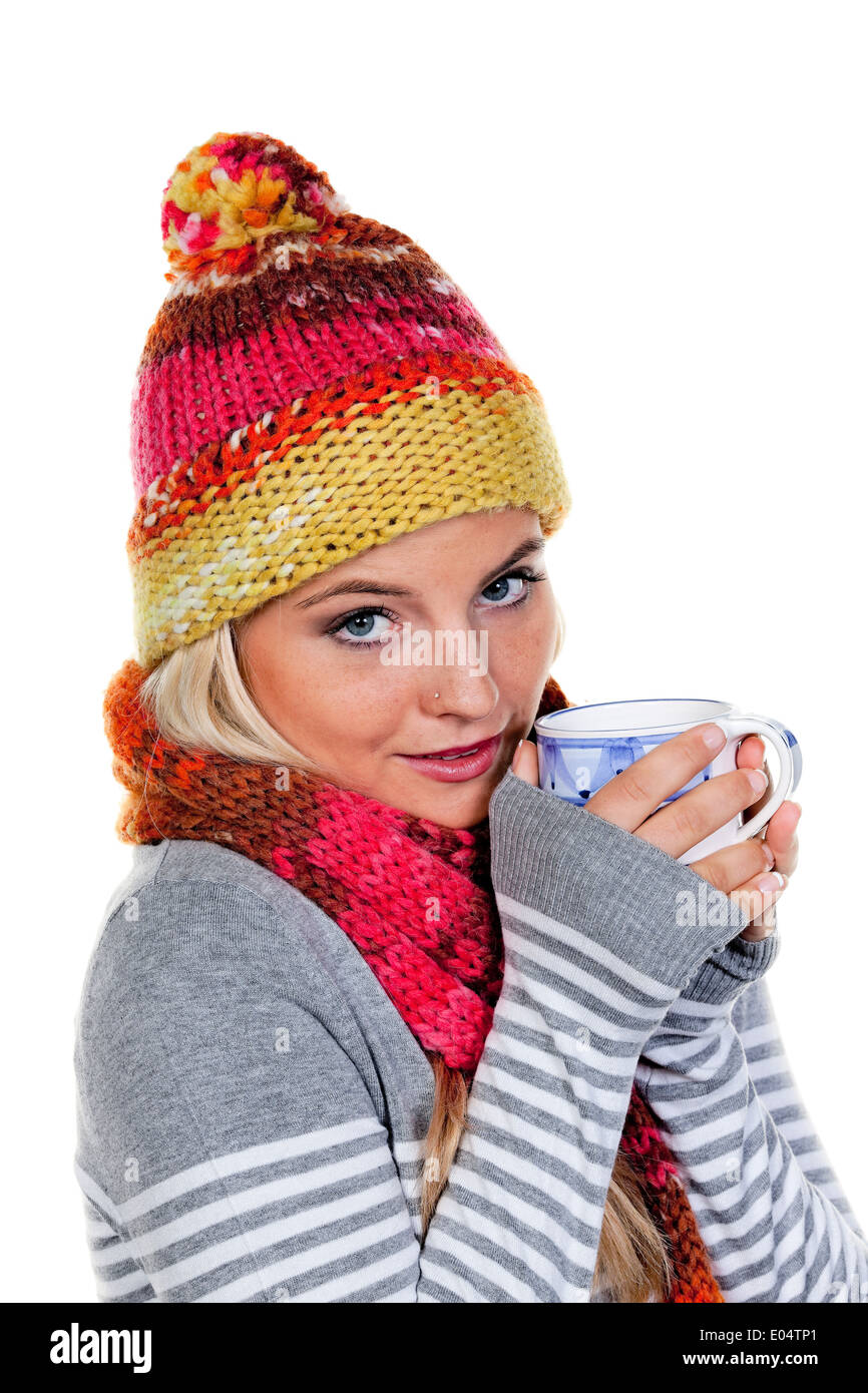 Young woman with voucher net warms herself with hot tea., Junge Frau mit Haube waermt sich mit heissem Tee. Stock Photo